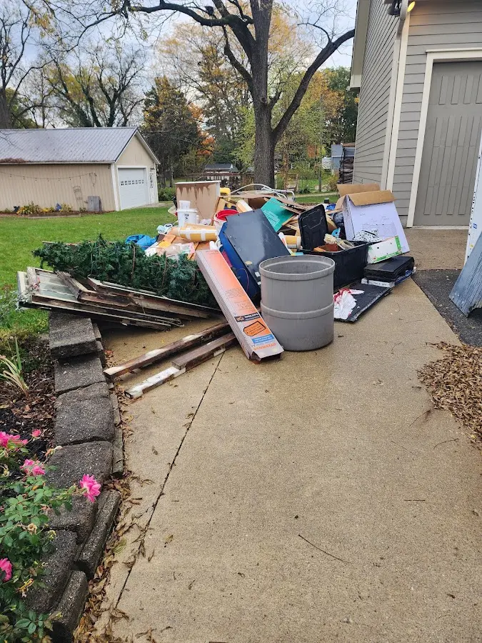 Dumpster being loaded with debris for Commercial Dumpster Rental in D'Iberville
